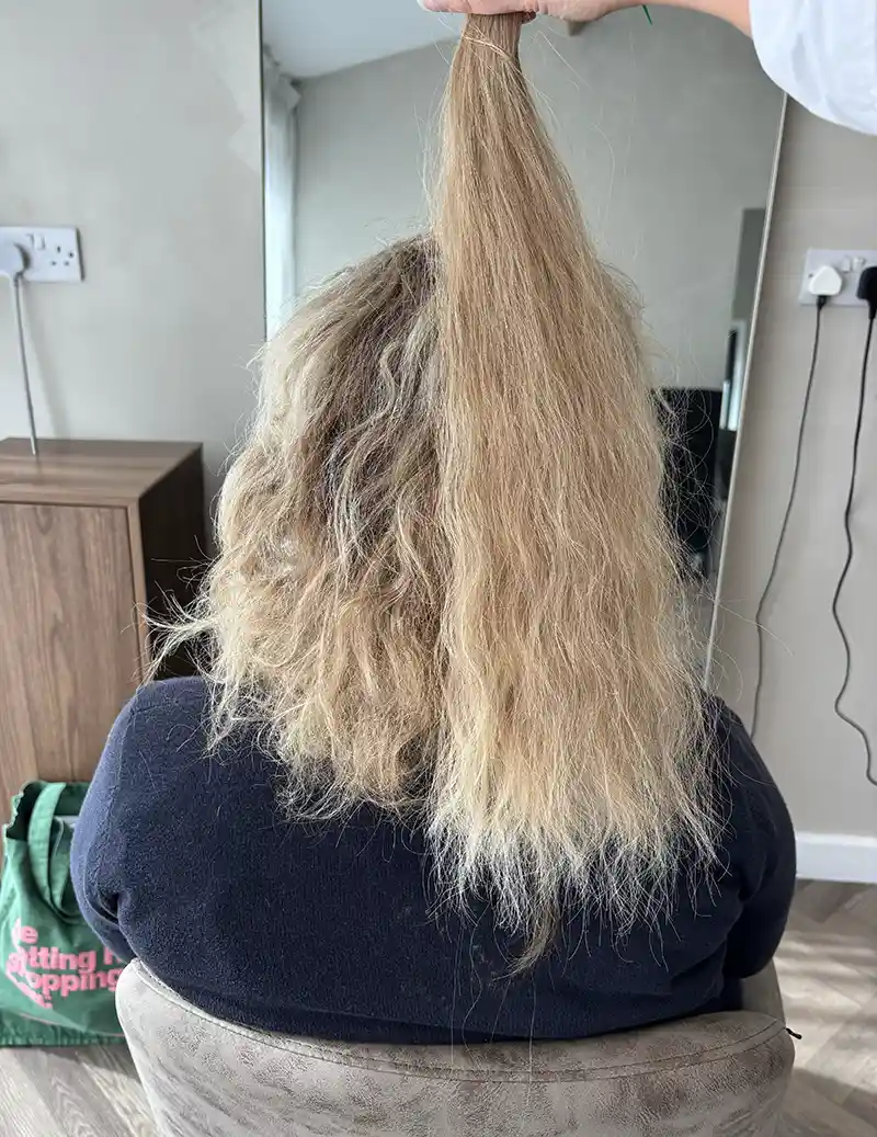 A model with curly hair extensions showing natural curl pattern matching